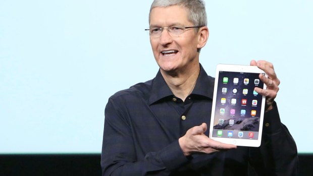 Apple CEO Tim Cook with a new iPad Air 2.