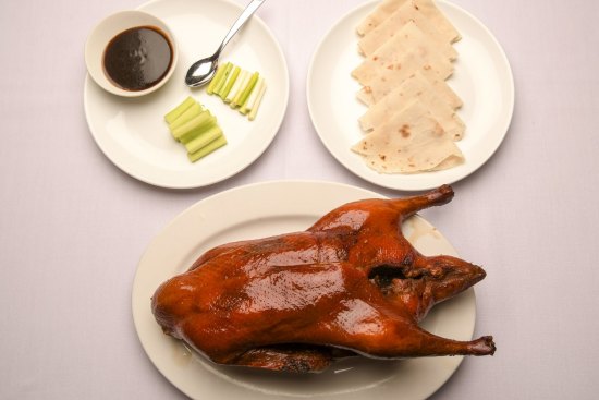 The signature Peking duck is presented tableside, then whisked off and assembled into pancakes.