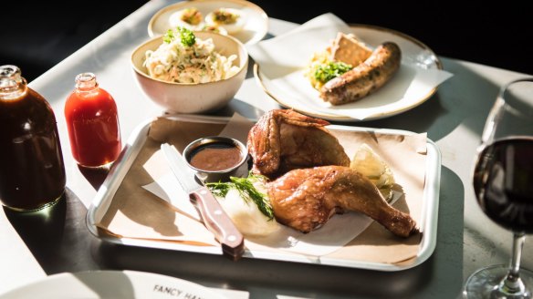 Smoked chicken, boudin sausage, sauces and coleslaw at Fancy Hank's new fancy digs.