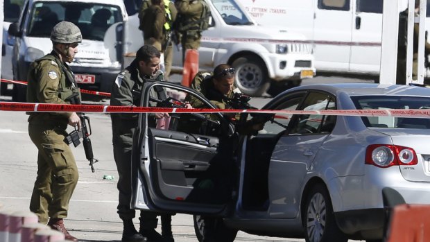 Israeli security forces at the checkpoint between the city of Ramallah and Jewish settlement of Beit El in the West Bank on Sunday after a Palestinian identified as Amjad Sukkari  allegedly wounded three people before being shot by Israeli military officers.