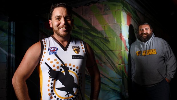 Tuggeranong Hawks player Tom Hodge sporting a jersey he designed for this weekend's Indigenous round. He is pictured with club vice-president Gerrit Wanganeen. 