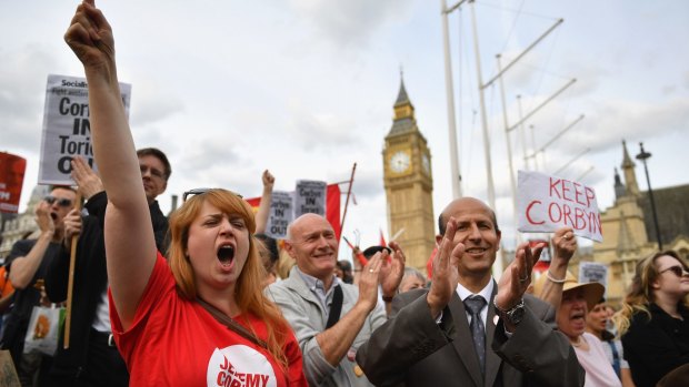 Supporters of Labour leader Jeremy Corbyn shout and clap during a 'Keep Corbyn' rally outside the Houses of Parliament.