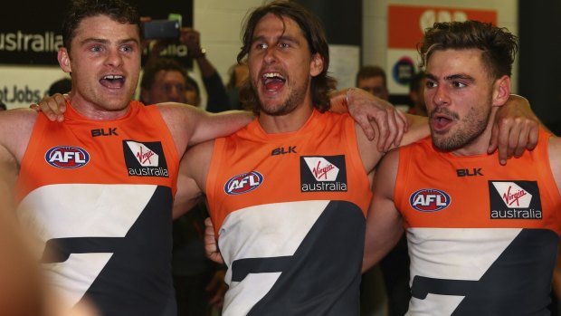 Feeling good: Heath Shaw, Ryan Griffen and Stephen Coniglio  sing the club song after the famous win.