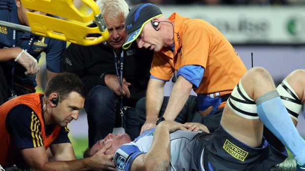 In the wars: Angus Cottrell of the Western Force is treated by medics.