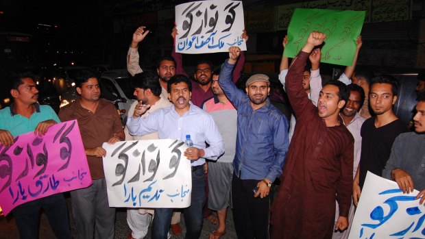 Supporters of the Tehreek-e-Insaf party, headed by Imran Khan, hold anti-government placards reading "Go Nawaz Go" in Lahore on Thursday.