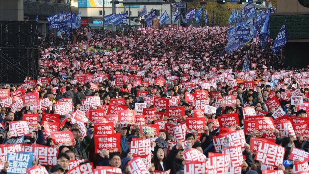 South Korean protesters hold up placards during a rally calling for South Korean President Park Geun-hye to step down in Seoul, South Korea.