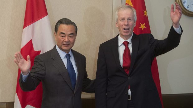  Wang Yi, left, and Canada's Minister of Foreign Affairs Stephane Dion pose for photographers on Wednesday.
