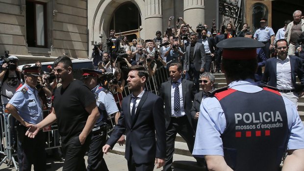 Messi leaves a Barcelona court in June.