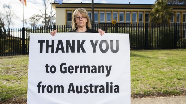 Lynn Russell of Yarralumla outside the German Embassy with a sign thanking Germany for their leadership in the refugee crisis in Europe.