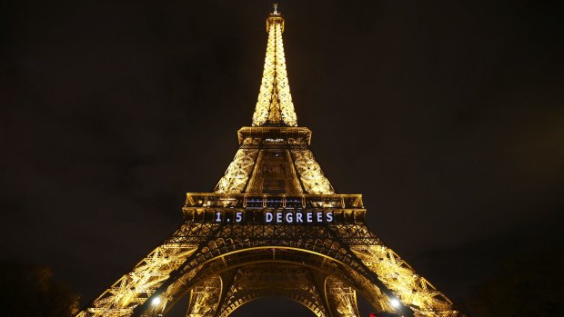 The slogan "1.5 DEGREES" is projected on the Eiffel Tower as part of the COP21, United Nations Climate Change Conference in Paris.