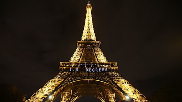 The slogan "1.5 DEGREES" is projected on the Eiffel Tower as part of the COP21, United Nations Climate Change Conference in Paris.