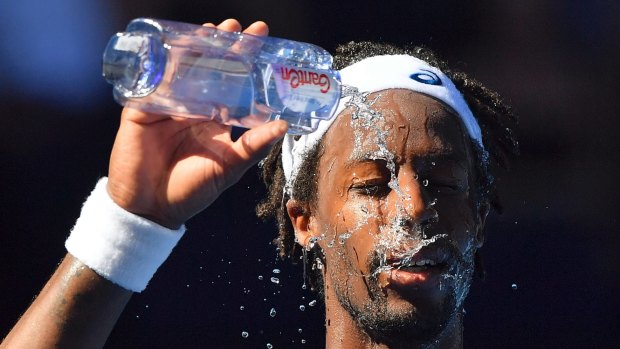 France's Gael Monfils showers himself with water during his second round match against Novak Djokovic.