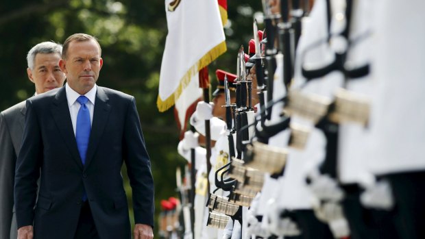 Tony Abbott and his Singaporean counterpart, Lee Hsien Loong, inspect an honour guard during a welcome ceremony on Mr Abbott's two-day visit to Singapore. 