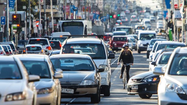 Trading parking and speed for safety, a cyclist rides on Sydney Road, Coburg.