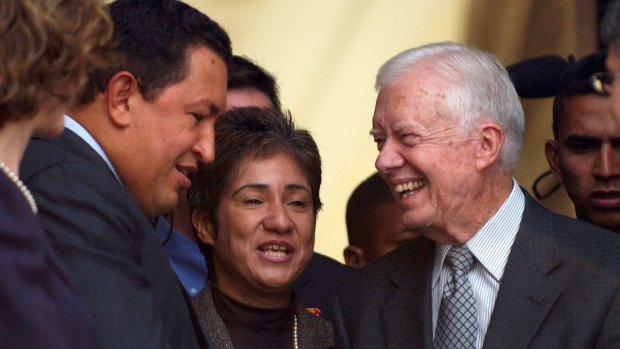 Hugo Chavez, President of Venezuela, left, speaks with former US president Jimmy Carter on the step of Miraflores palace in Caracas on Saturday. 