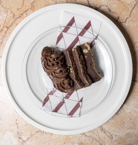 Chocolate brownie with chocolate mousse and chocolate pearls.