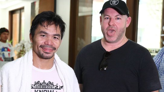 Working up a sweat: Manny Pacquiao with Andrew Webster after a training run on the streets of Manila.