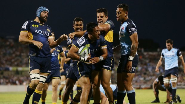 The Brumbies celebrate Christian Lealiifano's opening try against the Waratahs.