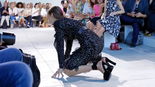 Model Bella Hadid falls as she walks the runway during the Michael Kors Spring 2017 collection, at Fashion Week in New York.