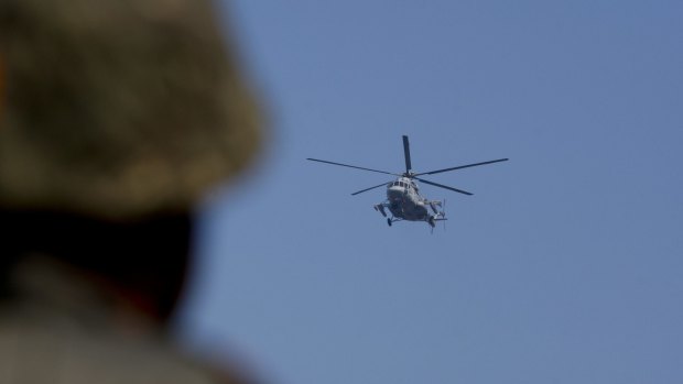 An army helicopter combs the area surrounding the Pathankot air force base in Pathankot, India on Sunday.