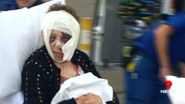 Anita Christanga is treated by paramedics after being bashed at her Toongabbie home.