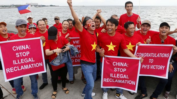 Vietnamese expatriates cheer at a rally by the Manila's baywalk before the Hague-based UN international arbitration tribunal announced its ruling on South China Sea.