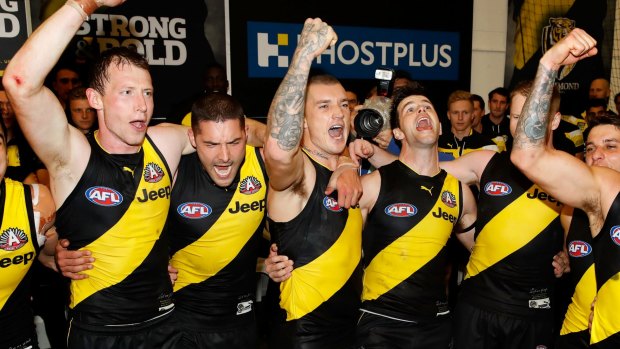 Yellow and black: Richmond players belt out the song on Anzac Eve.
