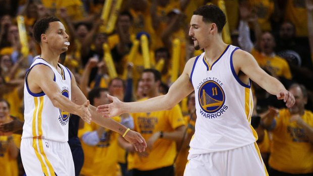 Stephen Curry and Klay Thompson celebrate in the second quarter.