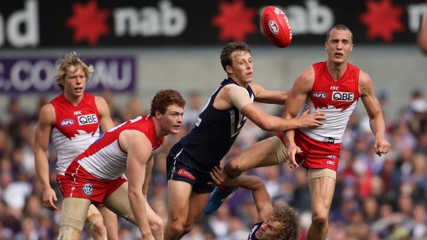 Getting better with age: Ted Richards gets a handball away under pressure against Fremantle.
