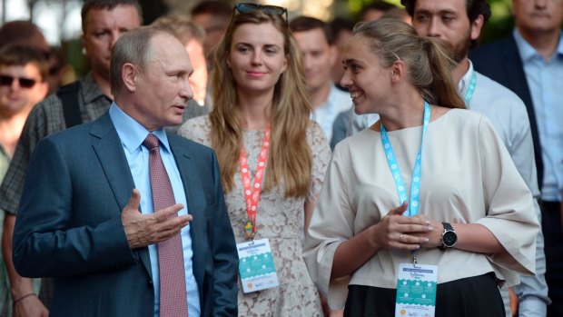 Russian President Vladimir Putin, left, visits a youth educational forum in Crimea earlier this month.