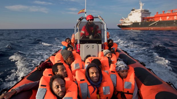 Eritrean migrants sit on a Proactiva Open Arms rescue boat in the Mediterranean sea, about 56 miles north of Sabratha, Libya, Thursday, April 6, 2017. 
