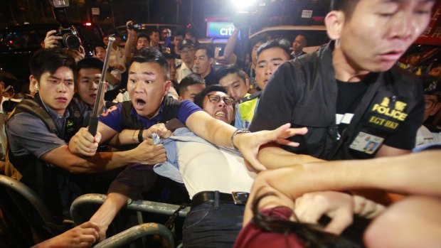 Protesters scuffle with police during clashes on the streets of Hong Kong on Sunday night.