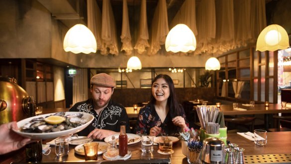 Fishing nets hang like petticoats inside nautical-themed bar Pearl Diver.