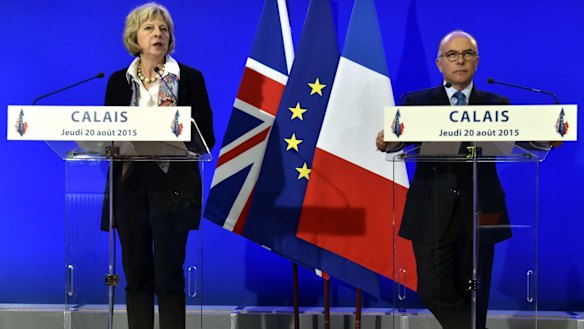 French Interior Minister Bernard Cazeneuve, right, and British Home Secretary Theresa May after signing bilateral agreements to address the migrant crisis.