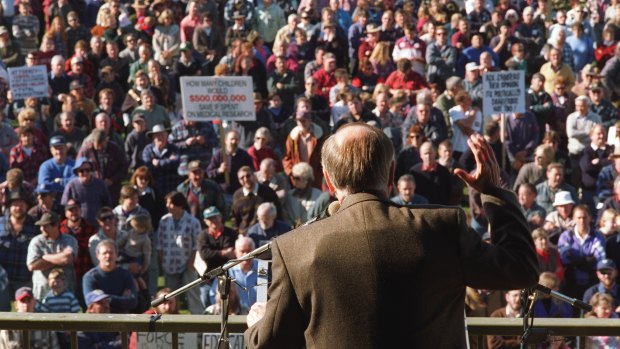 John Howard wears a bullet proof vest under his jacket as he addresses a gun control rally in Sale shortly after becoming prime minister.
