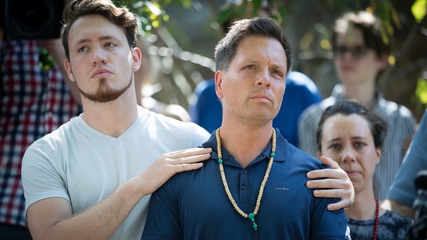 Don Damond is comforted by his son Zach Damond following the death of his fiancee Justine.