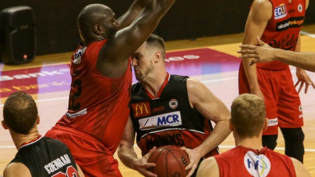 Banging bodies: Hawks centre AJ Ogilvy and Perth's Nate Jawai clash earlier in the season.