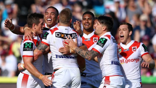 Happy Dragons: The Dragons celebrate Euan Aitken's try during their big win over Manly.