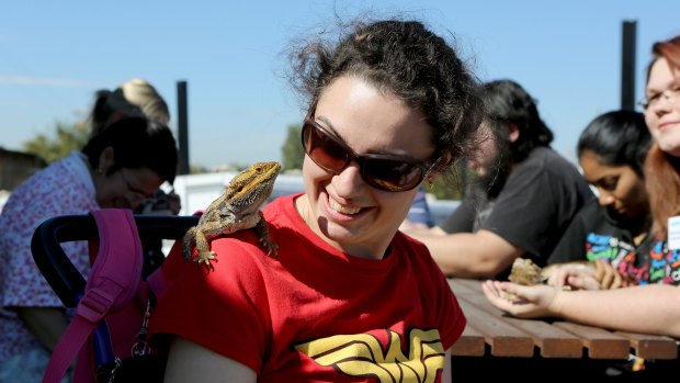 Charne Laybourne, with Bruce the Bearded Dragon, is a participant in the Happy Paws Happy Heart program.