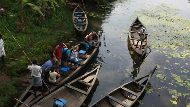 Exploring the backwaters in a traditional thoni canoe.