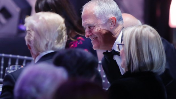 Malcolm Turnbull and his wife, Lucy, join Donald Trump as they take their seats during a dinner aboard the USS Intrepid.