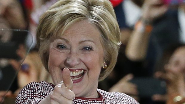 Democratic presidential candidate Hillary Clinton celebrates on stage after winning the New York state primary election.