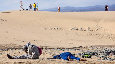 Two would-be immigrants rest at Maspalomas beach on Spain's Canary Islands.