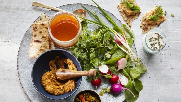 Abgoosht served with flatbread and salad.