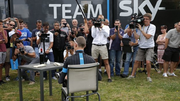Froome poses for the media outside one of three Team Sky motorhomes.