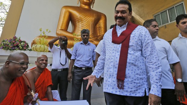 Former Sri Lankan President Mahinda Rajapaksa talks to Buddhist monks at a function organised last week to sign a petition against the UN push for investigations into alleged war atrocities in Sri Lanka.