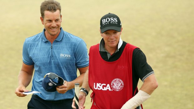 Bandaged up: caddie Gareth Lord walks off with Henrik Stenson after the Swede hits the lead in the US Open.