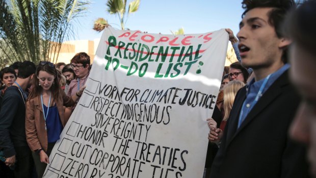 Environmental activists hold a banner during a protest against President-elect Donald Trump at the Climate Conference, known as COP22, in Marrakech, Morocco, on November 9.