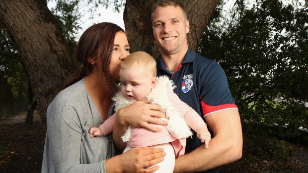  Western Bulldogs footballer Jake Stringer with his partner Abby and their daughter Milla.