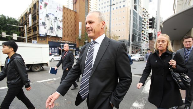 Angelo Memmolo (3rd from left) the officer incharge of the police investigation into the Martin Place siege leaves the John Maddison Tower where the Martin Place siege inquest is being held.